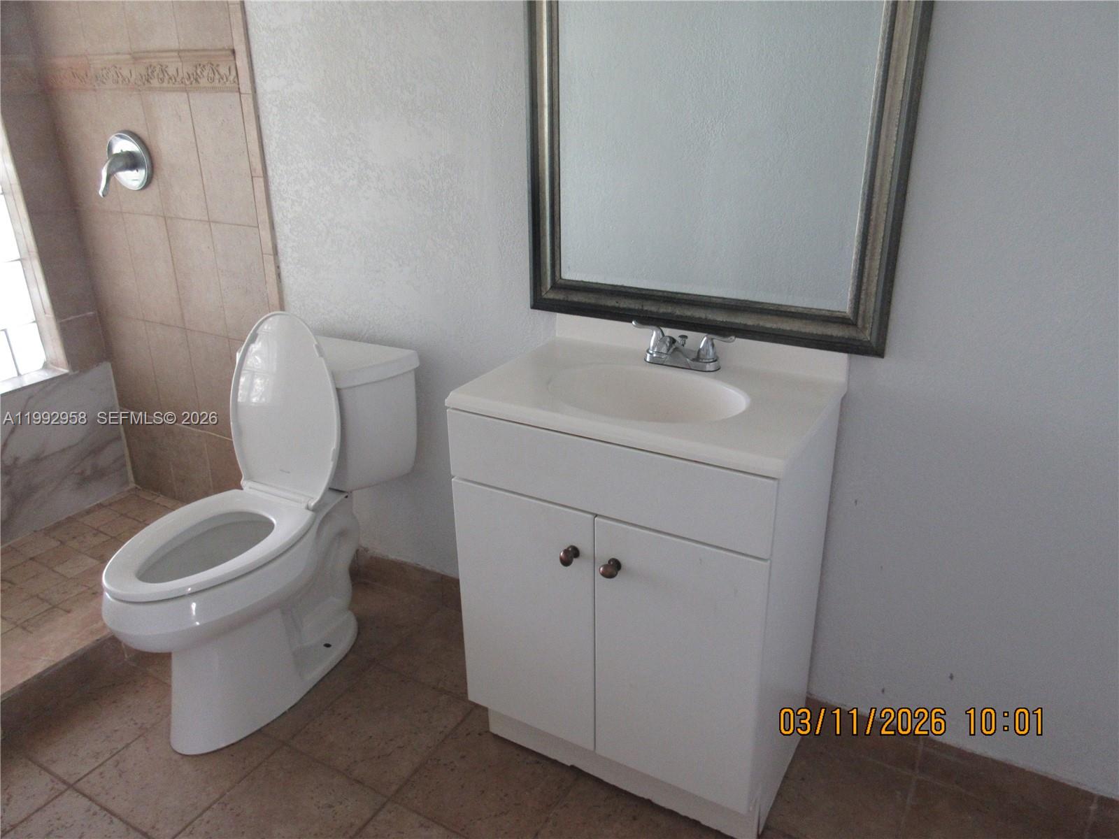 18420 Southwest 129th Avenue Miami, FL 33177 - Photo 12 of 17 a bathroom with a toilet sink and mirror