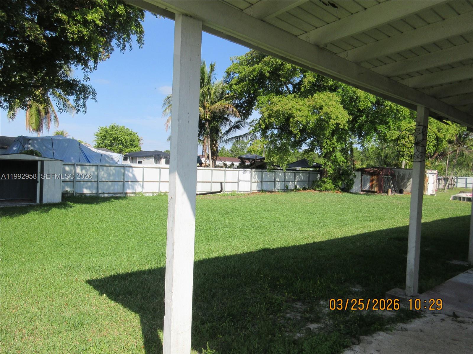 18420 Southwest 129th Avenue Miami, FL 33177 - Photo 16 of 17 a view of a house with a yard