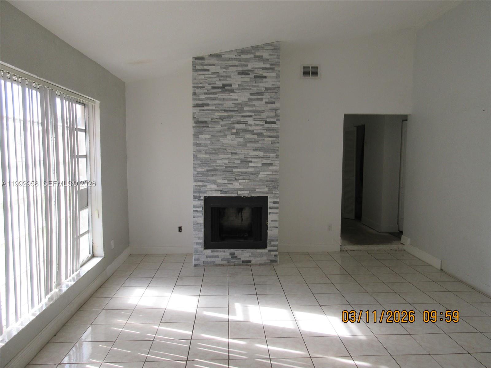 18420 Southwest 129th Avenue Miami, FL 33177 - Photo 2 of 17 a view of an empty room with window and fireplace