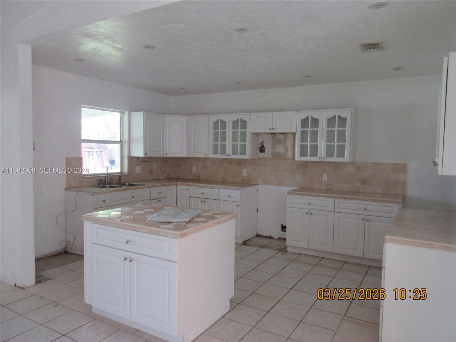 18420 Southwest 129th Avenue Miami, FL 33177 - Photo 5 of 17 a kitchen with cabinets appliances a sink and a window