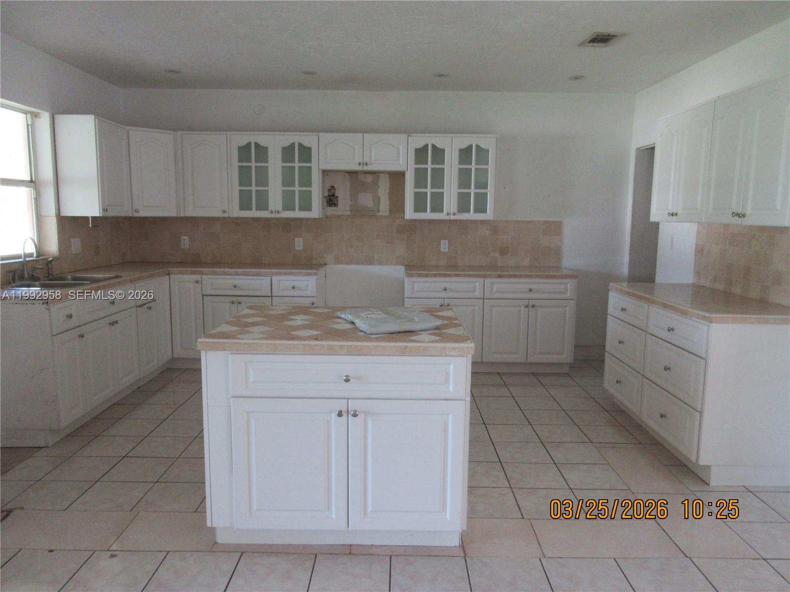 18420 Southwest 129th Avenue Miami, FL 33177 - Photo 6 of 17 a kitchen with a sink and cabinets