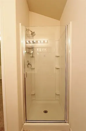 a bathroom with a glass shower door