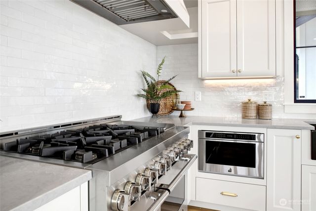 a view of a dining room with furniture a chandelier and wooden floor