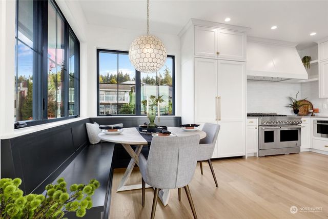 a dining room with furniture a large window and chairs