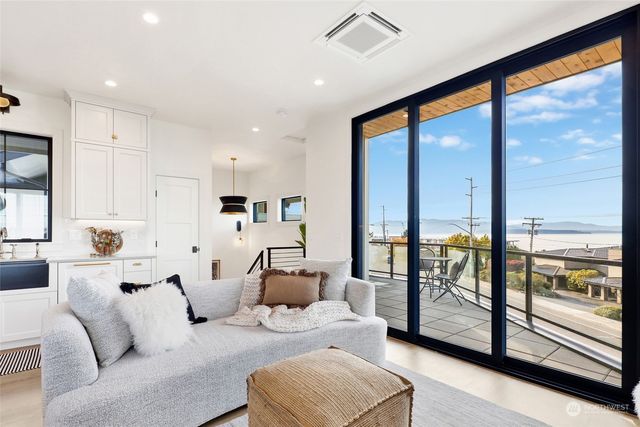 a living room with furniture and a floor to ceiling window