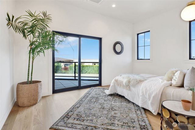 a bedroom with a large bed and a large window