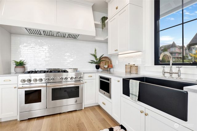 a kitchen with a sink and a potted plant