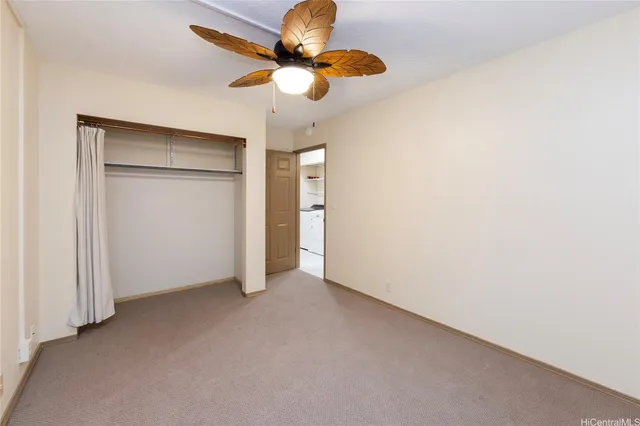 an empty room with a fan