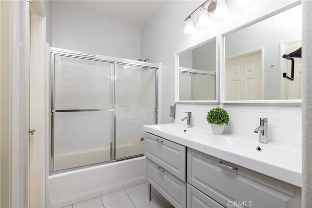 a bathroom with a bathtub sink vanity and mirror