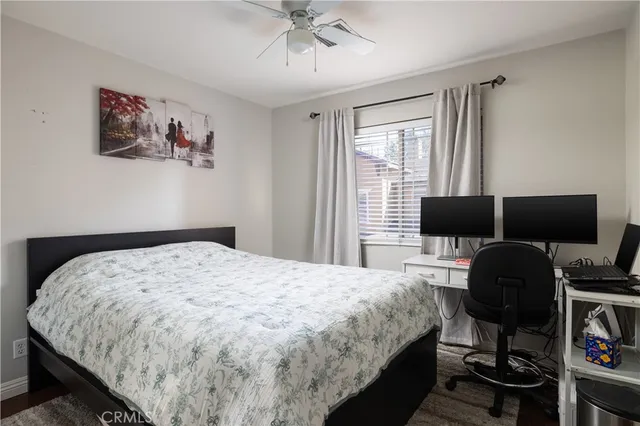 a bedroom with a bed and a desk