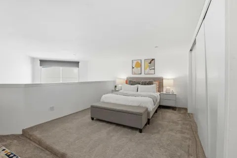 a bedroom with a bed and a table in it
