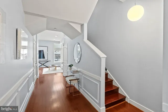 a view of a livingroom with wooden floor and furniture