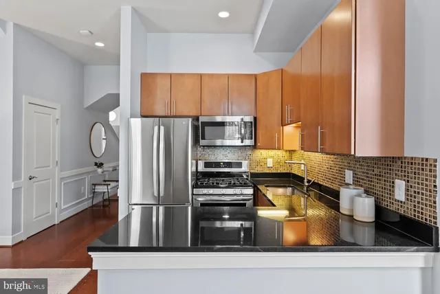 a kitchen with a refrigerator and a sink