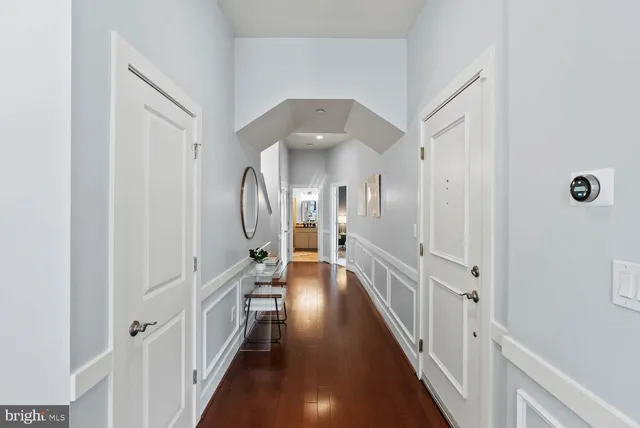 a view of a hallway with wooden floor and staircase