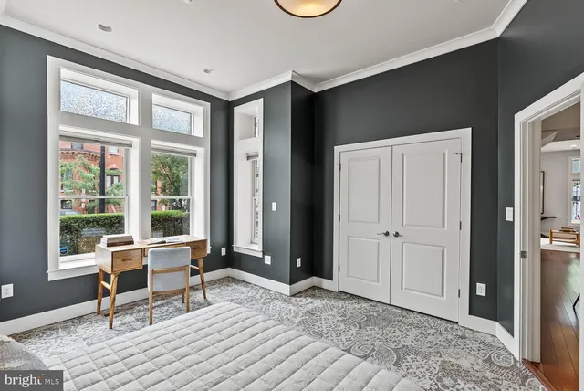 a workspace with wooden floor and a window