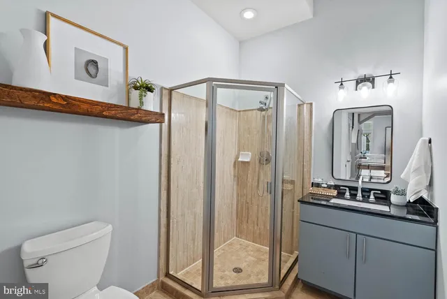 a bathroom with a shower a sink and a mirror