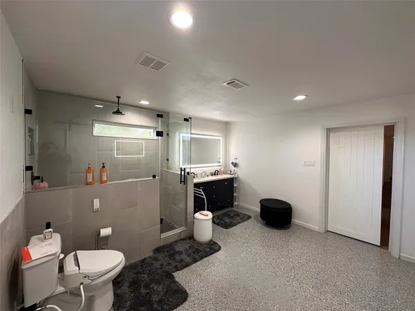 a bathroom with a toilet sink and shower