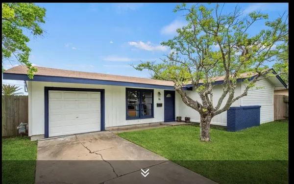 a house that has a tree in front of it