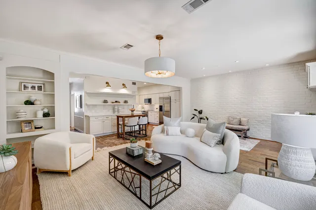 a living room with furniture a rug and a chandelier