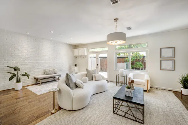 a living room with furniture and a chandelier