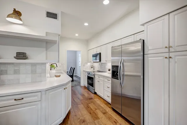a kitchen with cabinets and stainless steel appliances