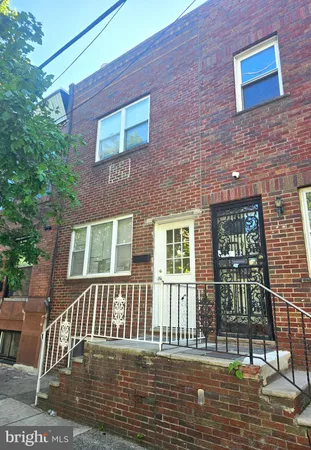 a view of a brick house with many windows
