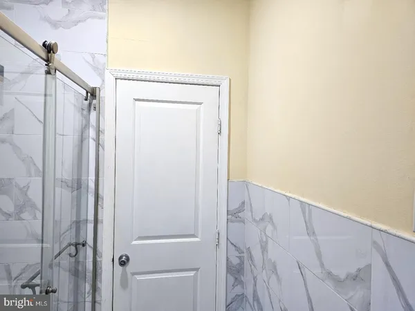 an empty room with wooden floor and closet
