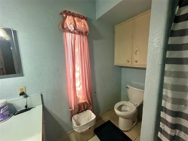 a living room with furniture a rug and wall paintings