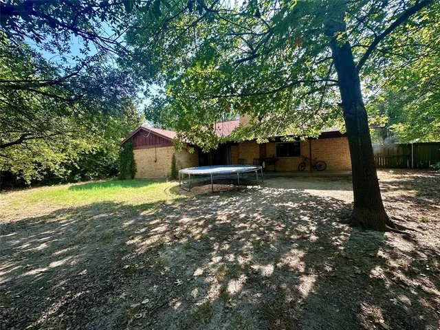 a view of a yard with a tree