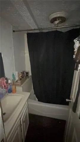 a view of a hallway with a white bed