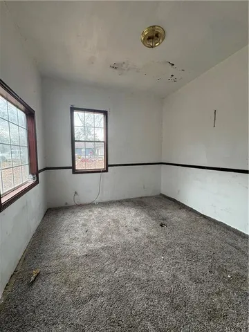 a view of a yard in front of a house with large trees