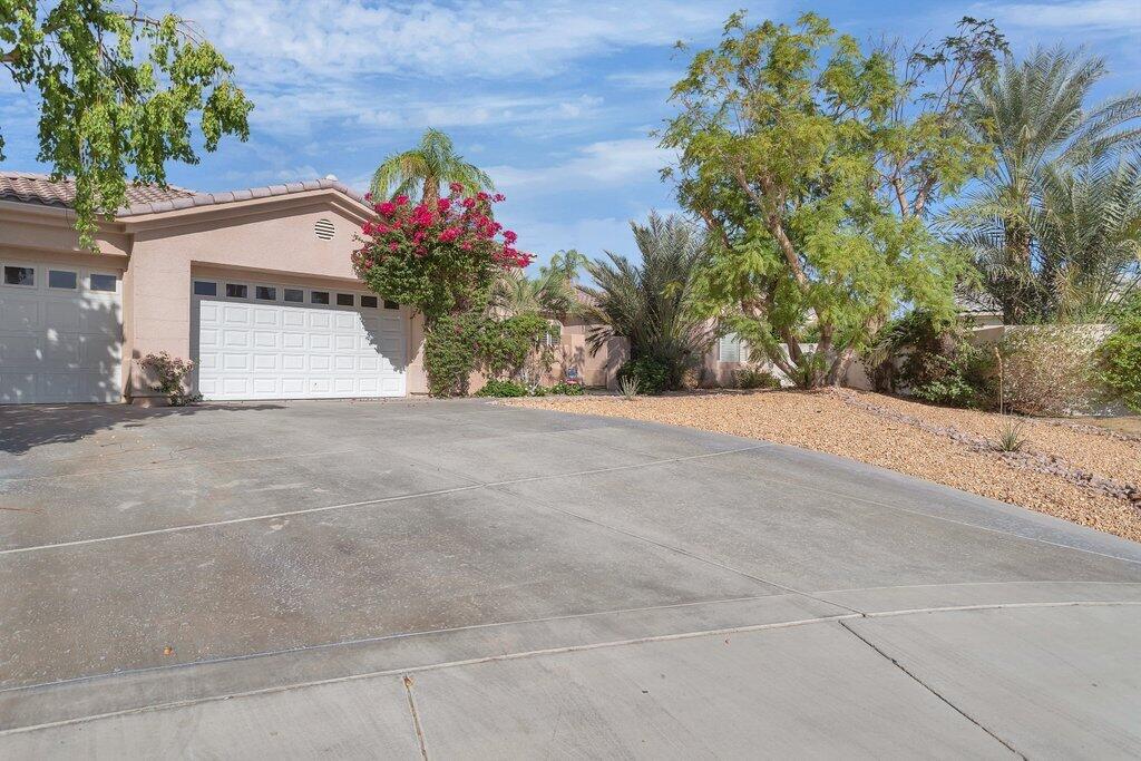 8 MacBeth Court Rancho Mirage, CA 92270 - Photo 40 of 46 a view of a house with a flower garden