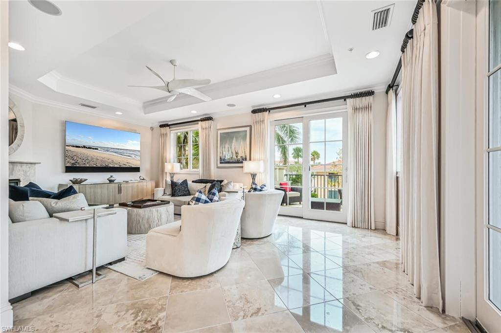 425 5th Street South, Unit A Naples, FL 34102 - Photo 11 of 44 a living room with fireplace furniture and a flat screen tv