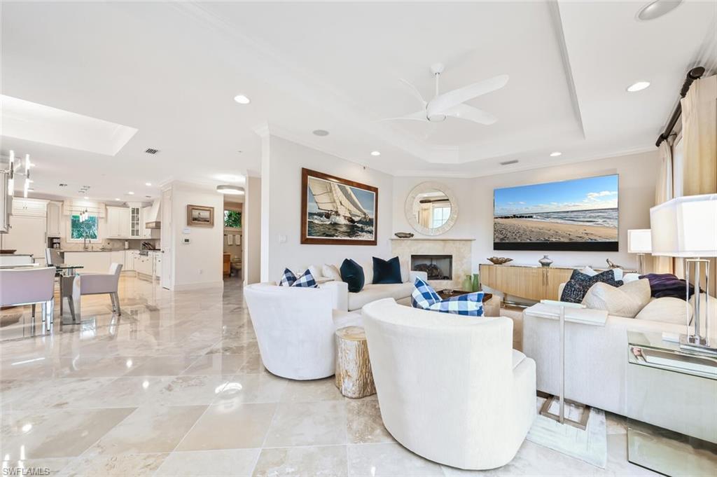 425 5th Street South, Unit A Naples, FL 34102 - Photo 12 of 44 a living room with fireplace furniture and a flat screen tv