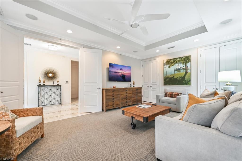 425 5th Street South, Unit A Naples, FL 34102 - Photo 16 of 44 a living room with furniture and a flat screen tv
