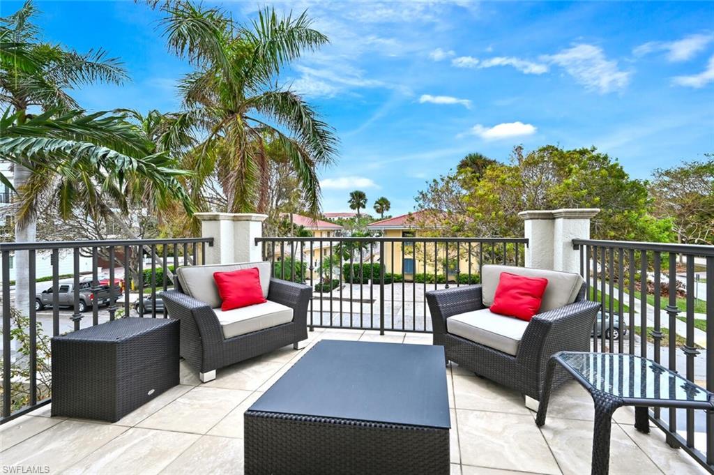 425 5th Street South, Unit A Naples, FL 34102 - Photo 17 of 44 a view of a patio with couches and a potted plant on a table
