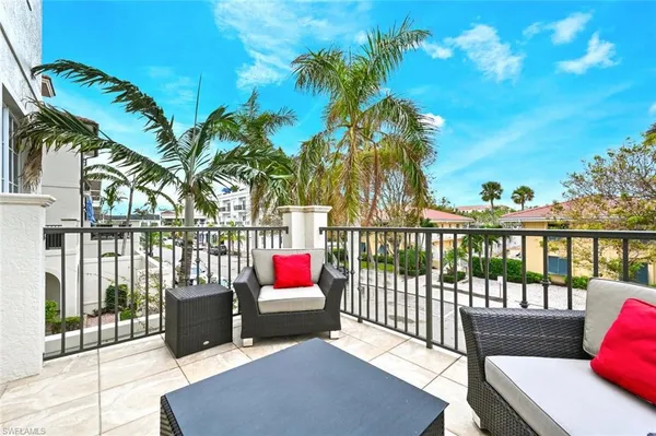 a view of a balcony with outdoor seating