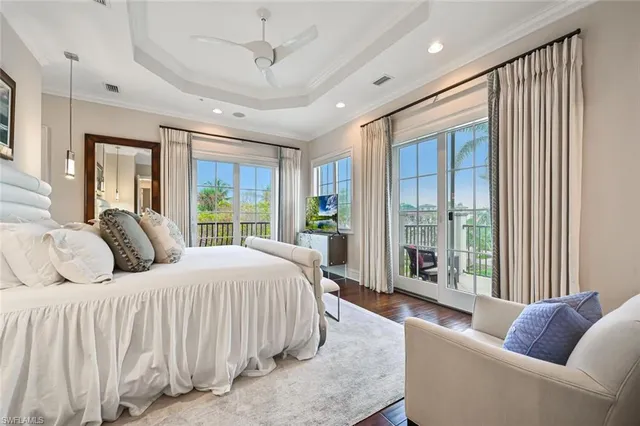 a bedroom with a large bed and a painting on the wall