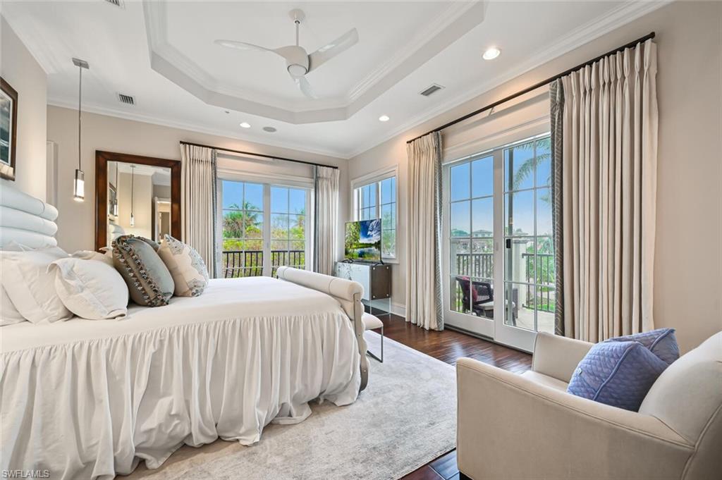 425 5th Street South, Unit A Naples, FL 34102 - Photo 22 of 44 a spacious bedroom with a large bed and a large window