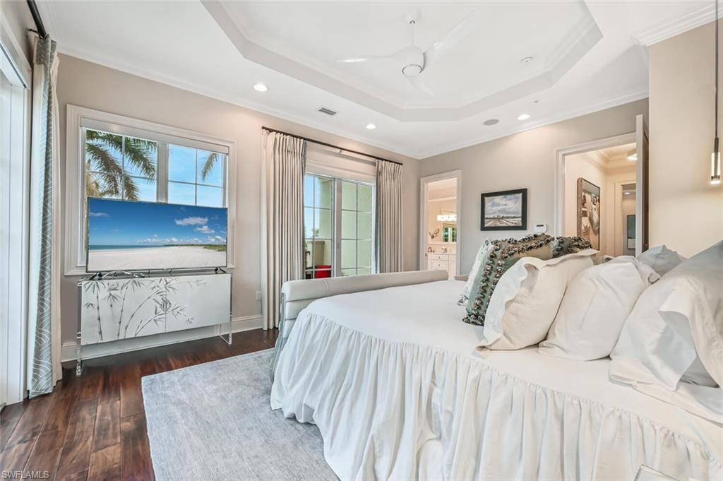 425 5th Street South, Unit A Naples, FL 34102 - Photo 23 of 44 a bedroom with a large bed and a painting on the wall
