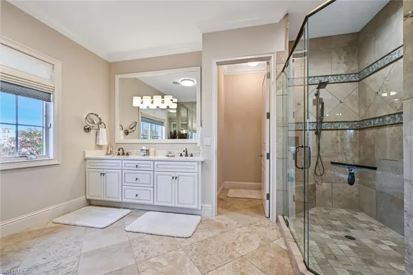 a spacious bathroom with a tub sink and mirror