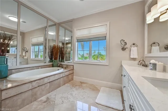 a bedroom with furniture and a large window