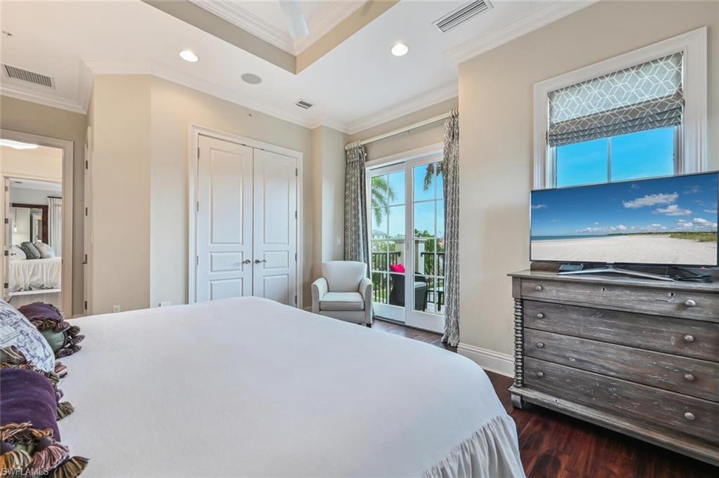 425 5th Street South, Unit A Naples, FL 34102 - Photo 27 of 44 a bedroom with a bed and a dresser