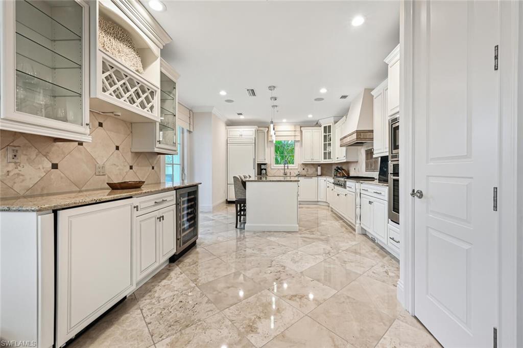 425 5th Street South, Unit A Naples, FL 34102 - Photo 3 of 44 a kitchen with stainless steel appliances granite countertop a refrigerator sink and cabinets