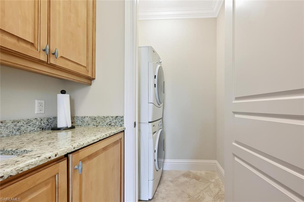 425 5th Street South, Unit A Naples, FL 34102 - Photo 31 of 44 a kitchen with granite countertop cabinets and refrigerator