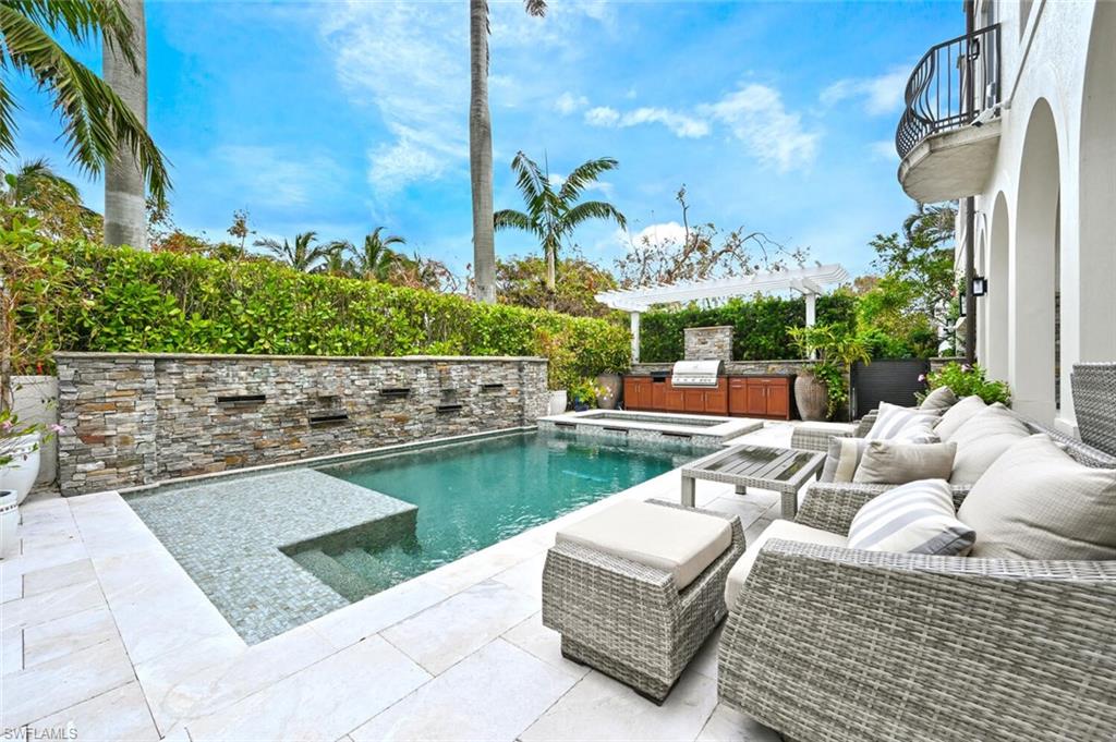 425 5th Street South, Unit A Naples, FL 34102 - Photo 35 of 44 a view of swimming pool with outdoor seating and plants