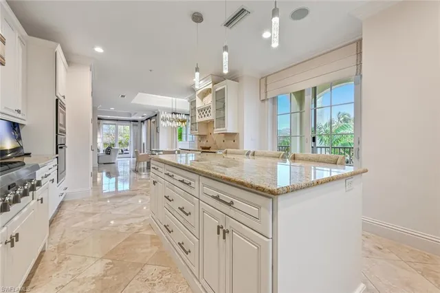 a bathroom with granite countertop a sink and a refrigerator