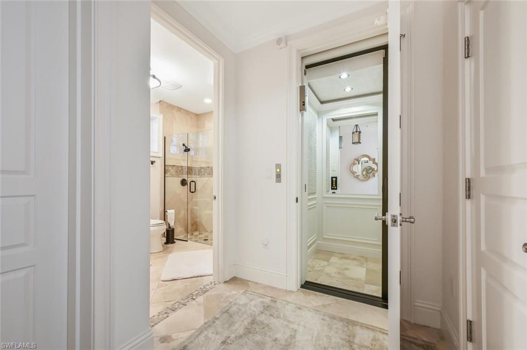425 5th Street South, Unit A Naples, FL 34102 - Photo 44 of 44 wooden view of a bathroom from a hallway