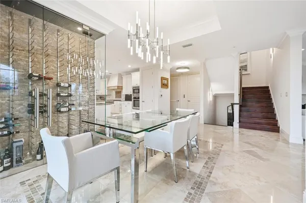 a dining room with furniture and a chandelier
