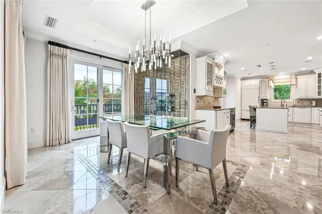 a view of a dining room with furniture large windows and wooden floor
